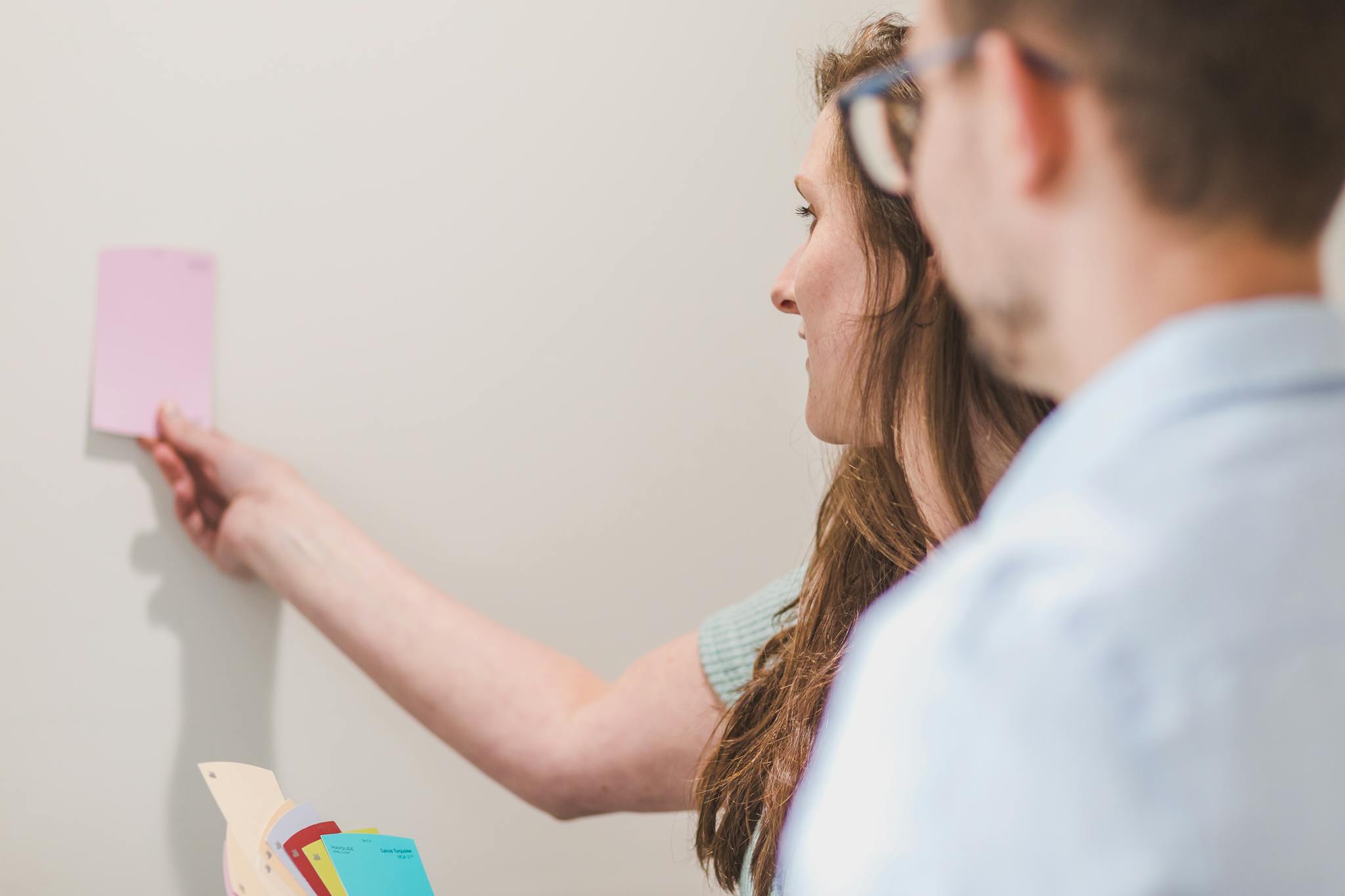 A couple deliberates on paint color selections for their home interior renovation project.