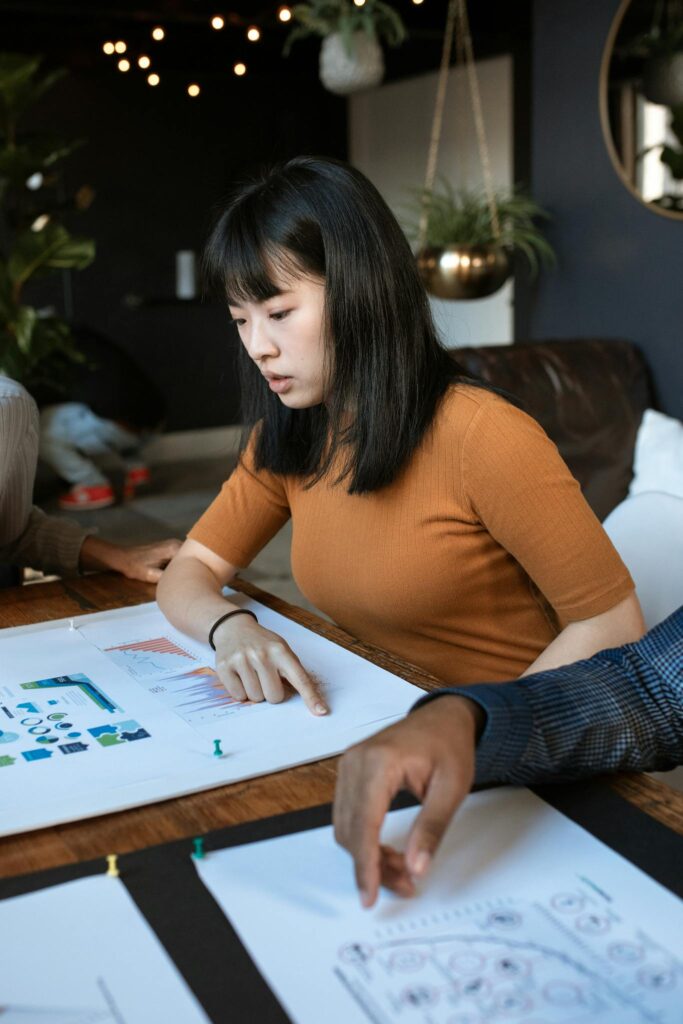 Young woman engaged in work at a creative office space with design documents.
